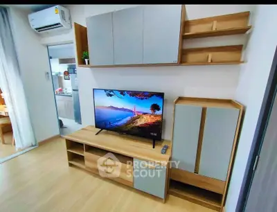 Modern living room with stylish wooden furniture and flat-screen TV, showcasing contemporary interior design.