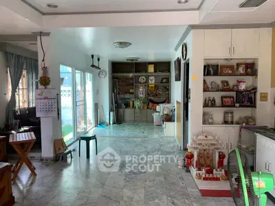 Spacious living area with marble flooring and built-in storage, perfect for family gatherings.