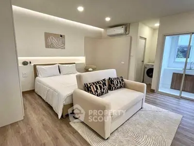 Modern studio apartment with cozy bed and stylish decor