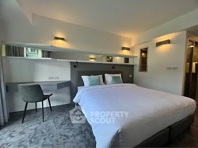 Modern bedroom with stylish decor and cozy ambiance, featuring a comfortable bed and sleek furnishings.