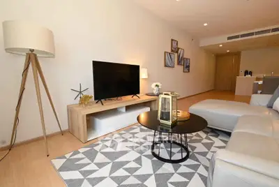 Modern living room with stylish decor and large TV in a spacious apartment