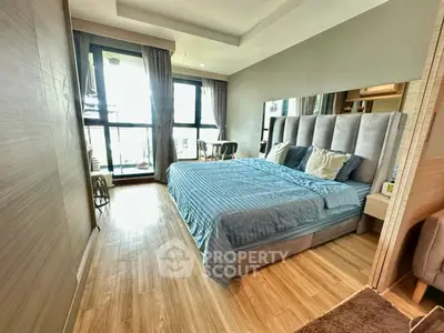 Spacious modern bedroom with large windows and elegant decor