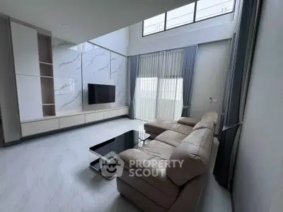 Spacious modern living room with high ceilings and elegant marble accents