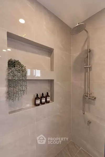Modern bathroom with sleek shower and built-in shelves