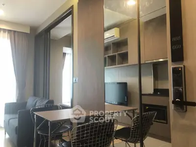 Modern living room with sleek furniture and wall-mounted TV in a stylish apartment.