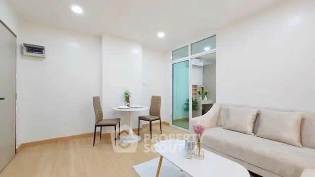 Modern living room with cozy seating and elegant decor in a bright apartment.