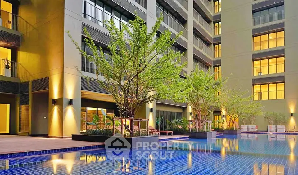 Luxurious apartment building with stunning pool and modern architecture.