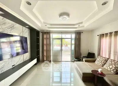Spacious living room with modern decor and large windows for natural light