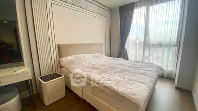 Modern bedroom with large window and elegant decor in a high-rise apartment.