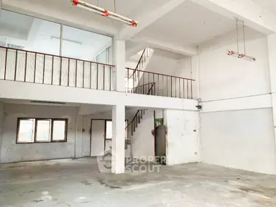 Spacious industrial loft with high ceilings and a mezzanine level, offering a blank canvas for creative interior design and customization.