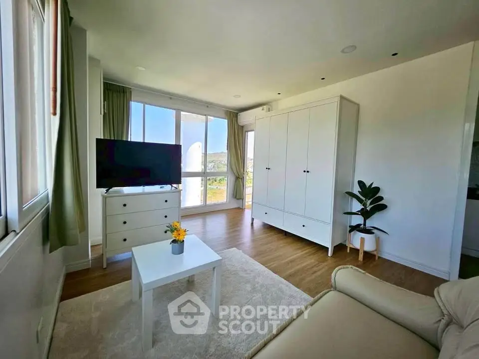 Bright living room with modern furniture and large window view