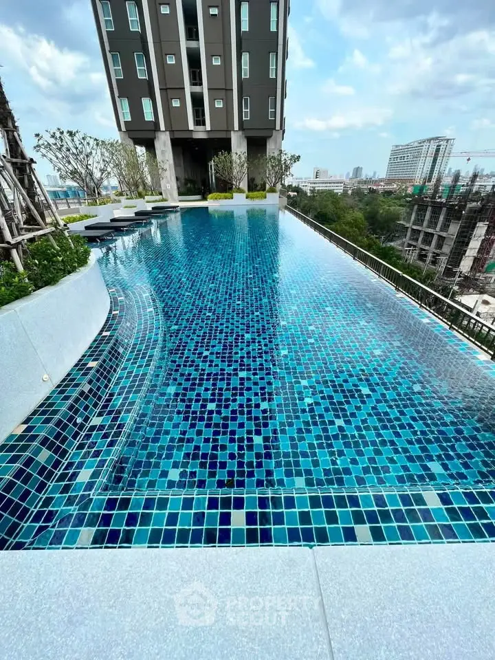 Luxurious rooftop infinity pool with stunning city views in modern high-rise building.