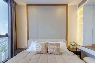 Luxurious bedroom with elegant decor and stunning city view from window.