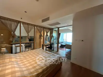 Spacious bedroom with elegant decor and open view to living area