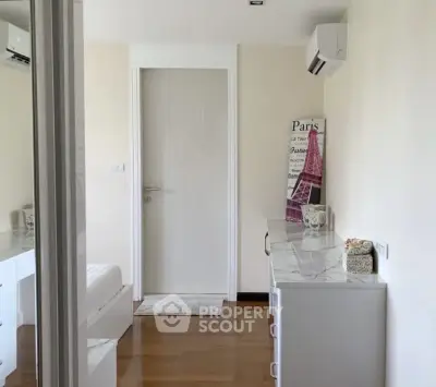Chic bedroom with modern decor and air conditioning, featuring elegant wooden flooring and stylish furnishings.