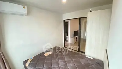 Cozy bedroom with air conditioning and sliding door to living area, perfect for modern living.