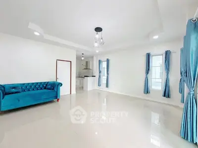 Spacious living room with elegant blue sofa and modern lighting