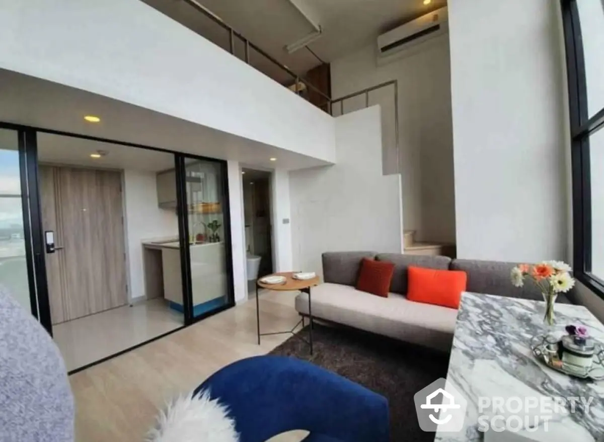 Modern loft apartment with open living area and stylish decor.