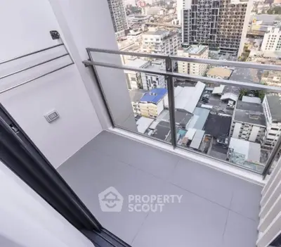 Modern high-rise balcony with stunning cityscape view, perfect for urban living.