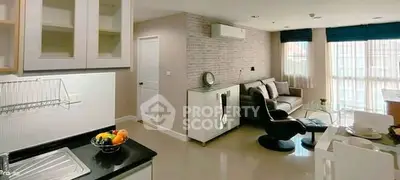 Modern living room with sleek kitchen and stylish decor