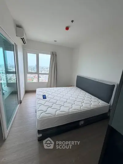 Spacious bedroom with city view in modern apartment