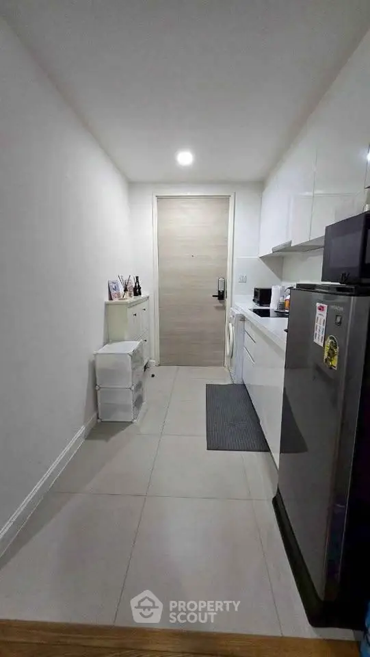 Modern kitchen with sleek appliances and ample storage in a compact layout.