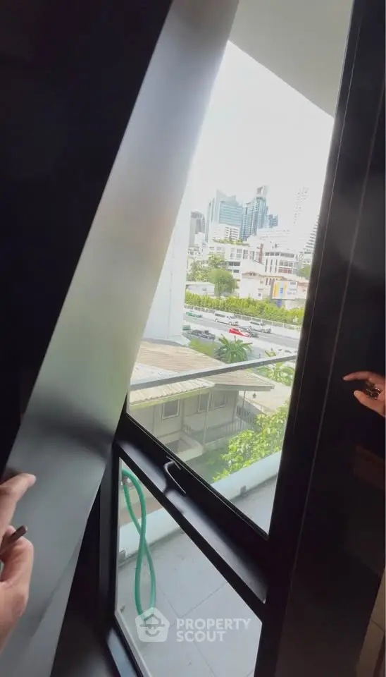 Modern apartment window with city view and balcony