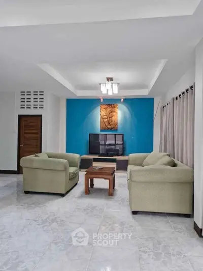 Spacious living room with modern decor and comfortable seating