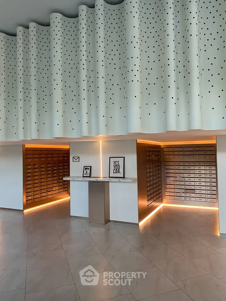 Modern building lobby with stylish mailboxes and unique ceiling design