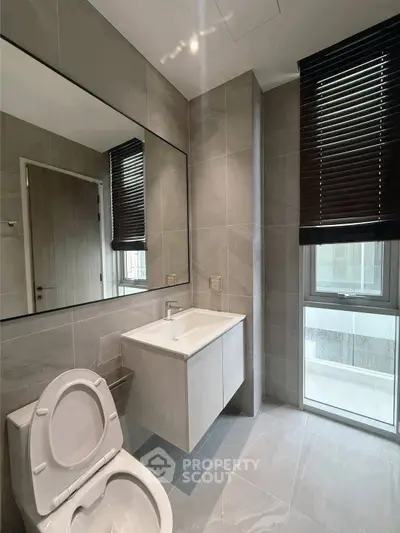 Modern bathroom with sleek design and large mirror