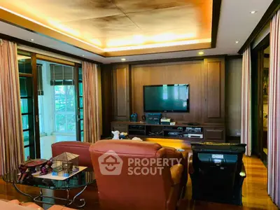 Luxurious living room with elegant wood paneling and modern entertainment setup