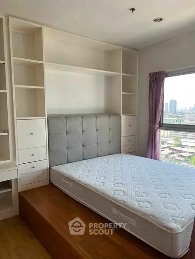 Spacious bedroom with built-in storage and city view, perfect for modern living.