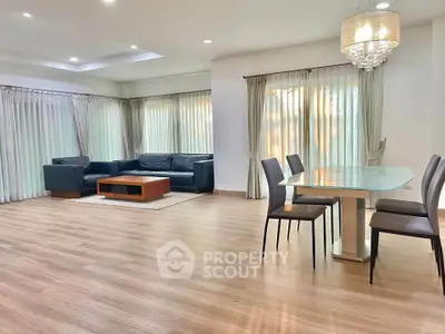 Spacious modern living room with elegant dining area and natural light