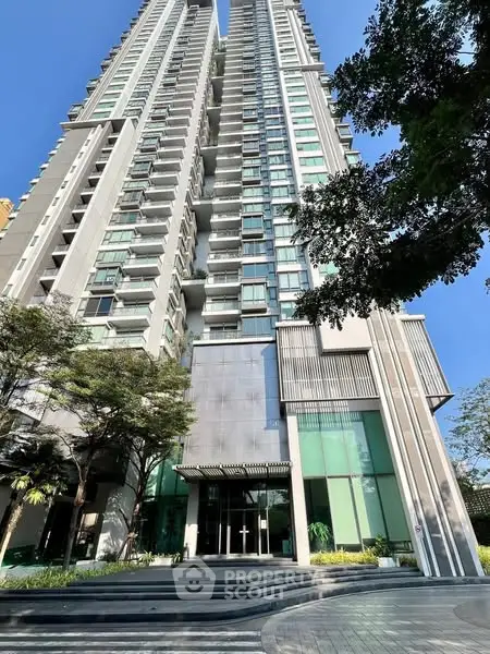 Stunning modern high-rise building with sleek architecture and lush greenery.