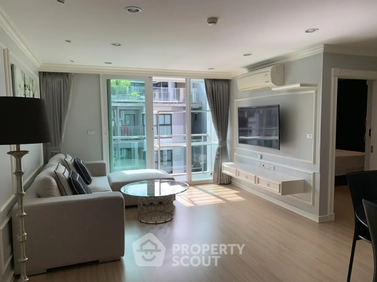 Spacious modern living room with large windows and elegant decor in a luxury apartment.