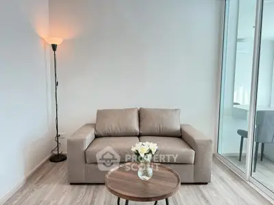 Modern living room with stylish sofa and floor lamp, featuring a cozy ambiance and elegant decor.