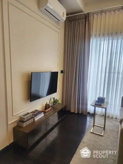 Modern living room with sleek TV setup and elegant curtains