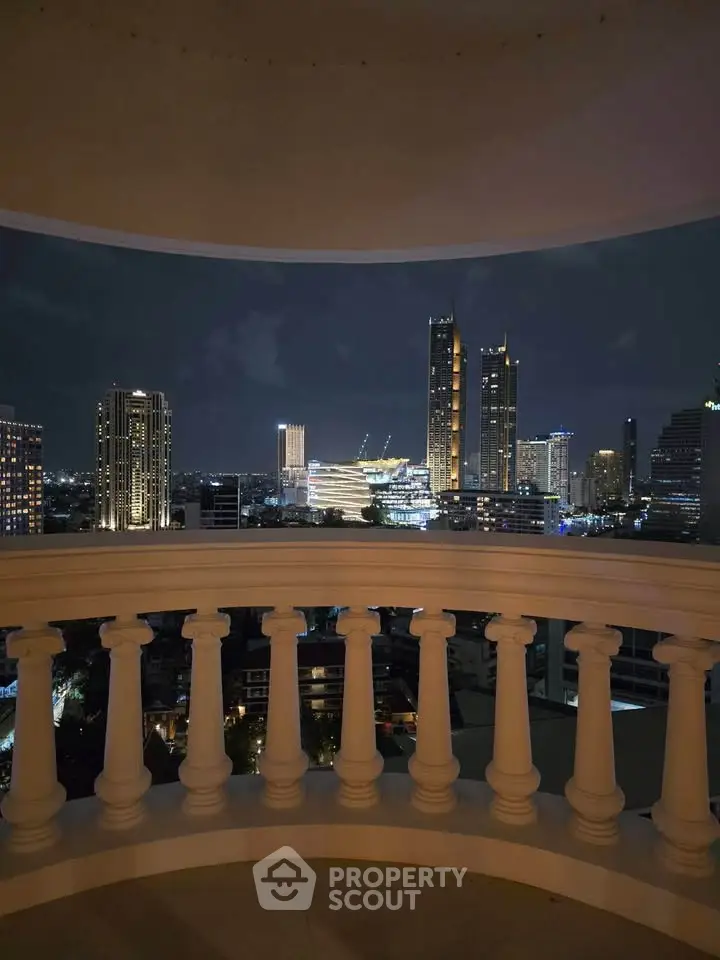 Stunning night cityscape view from a balcony with elegant balustrade, showcasing urban skyline lights.