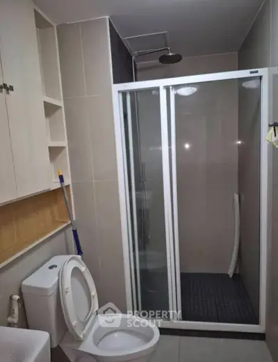 Modern bathroom with shower and toilet in sleek apartment
