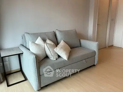 Modern living room with stylish grey sofa and wooden floor
