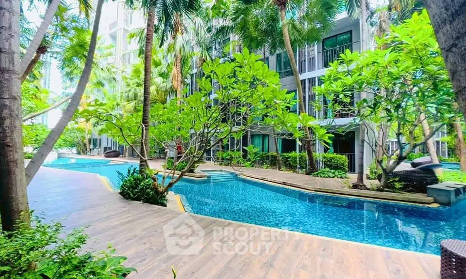 Luxurious condo with tropical pool and lush garden surroundings, perfect for relaxation and leisure.