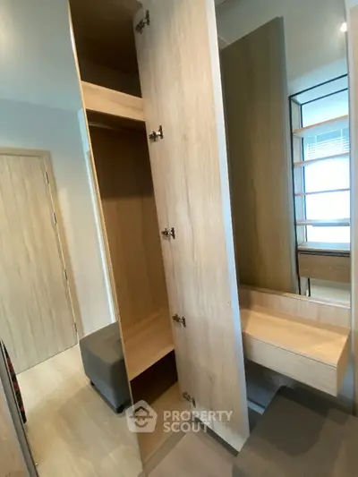 Modern wooden wardrobe with open doors in a stylish bedroom