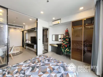 Modern bedroom with festive decor and sleek design in a stylish apartment.