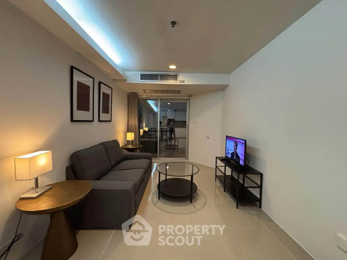 Modern living room with sleek furniture and ambient lighting in a stylish apartment.