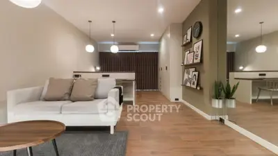 Modern living room with stylish decor and cozy seating area, perfect for relaxation.