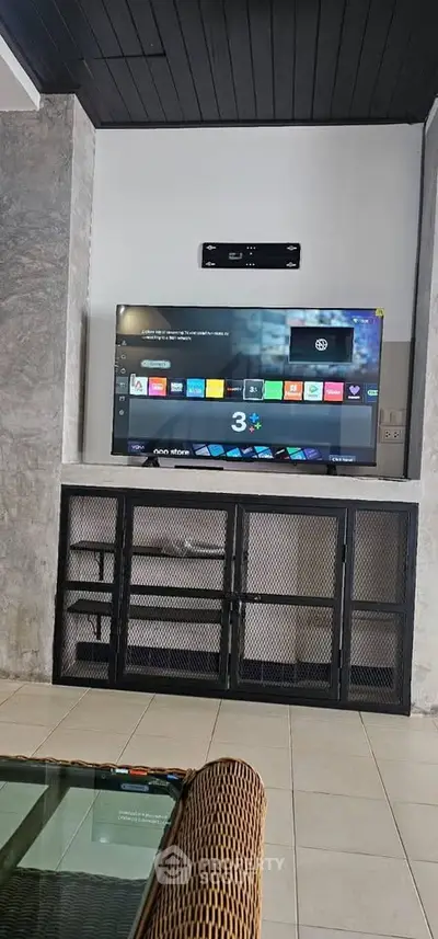 Modern living room with wall-mounted TV and stylish shelving unit