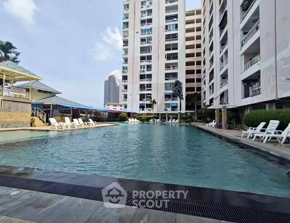 Luxurious apartment complex with a stunning outdoor pool and modern amenities.