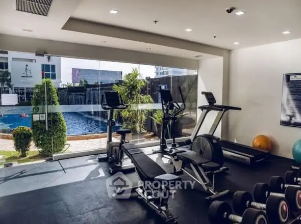 Modern gym with pool view in luxury real estate property