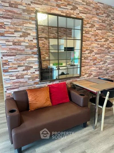 Stylish living room with modern brick accent wall and cozy seating area.
