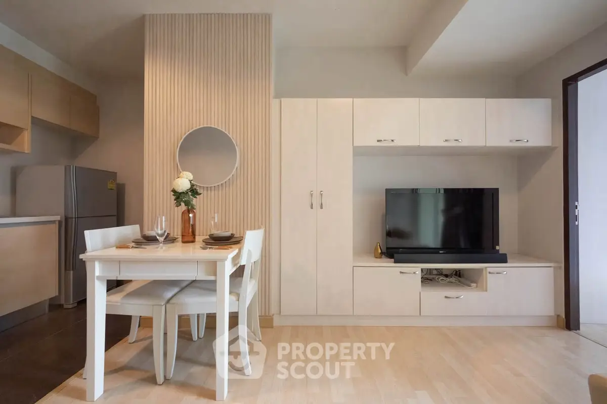 Modern living room with sleek furniture and integrated kitchen area, perfect for stylish urban living.